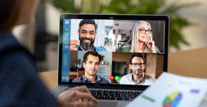 laptop open to a remote meeting with four people