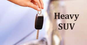 a person holding a key fob with the words "heavy SUV" next to it