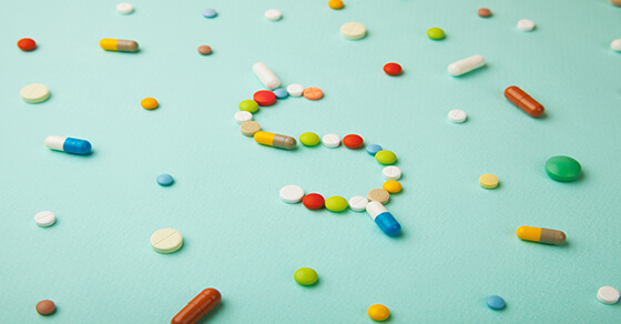 pills on a table forming the $ symbol.
