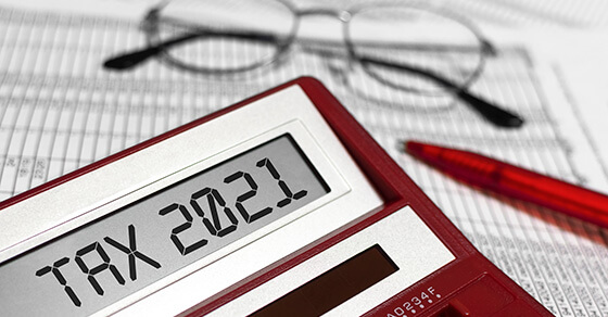 calculator and glasses on top excel documents.