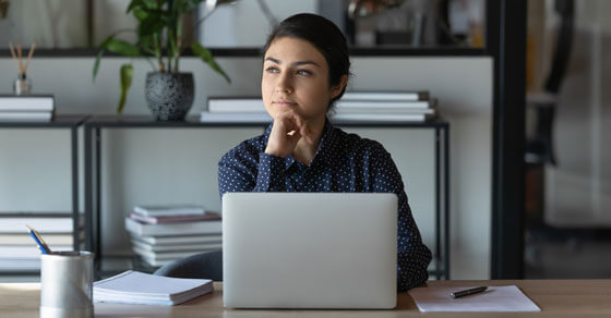 individual in a room in front of an open laptop screen