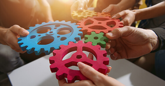 hand held gears of different shapes and colors placed together