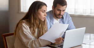 a man and a woman looking at a piece of paper