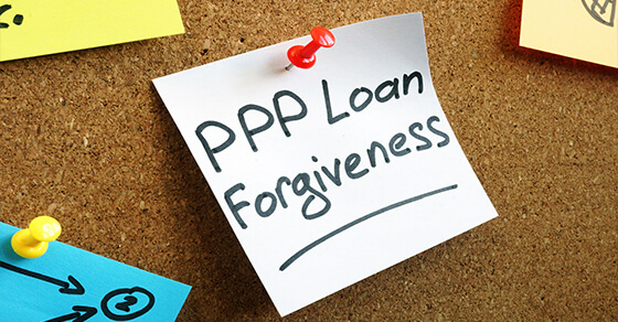 post-it on a bulletin board with "PPP Loan Forgiveness" written on it.