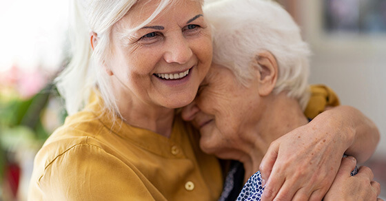 a younger woman hugging an older woman