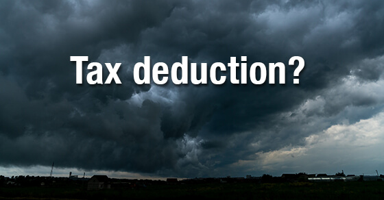 image of a storm and dark clouds with the words "tax deduction?" in the clouds.