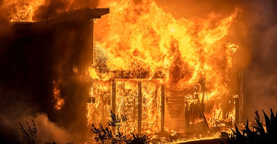 image of an actively burning building with billows of orange and red fire.