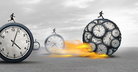 Clocks with people running on top of them, as in a race, and fire coming out of the bottom of the clocks.