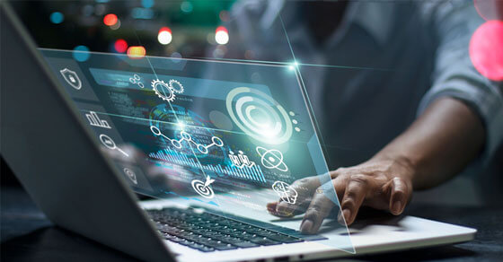 image of a persons hand on a laptop keyboard and a virtual screen appearing.