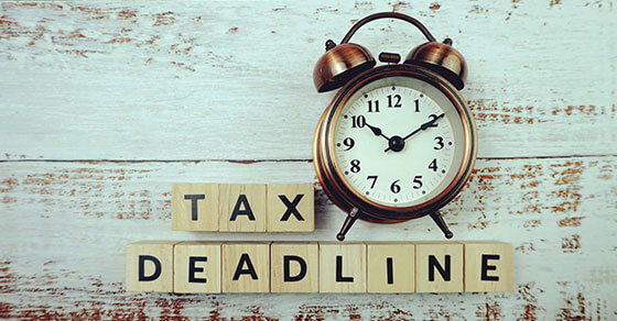 image of a clock and the scrabble letters next to it that read "tax deadline"