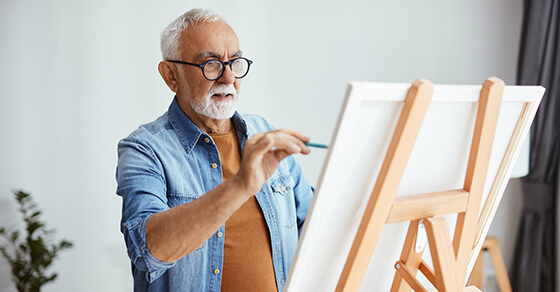 an artist drawing on a canvas on an easel