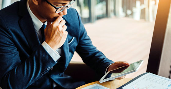 image of an individual looking at their cell phone intently.