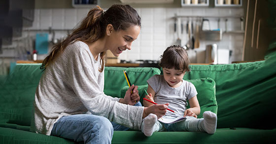adult and child sitting on a couch together.
