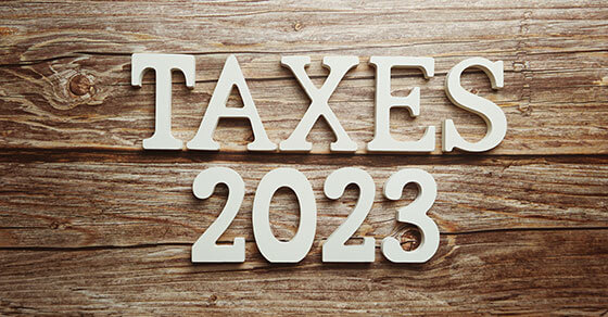 "Taxes 2023" words over wood.
