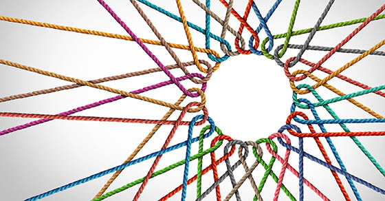 Business Unity and connection partnership as ropes shaped as a circle in a group of diverse strings connected together shaped as a support symbol expressing the feeling of teamwork and togetherness.