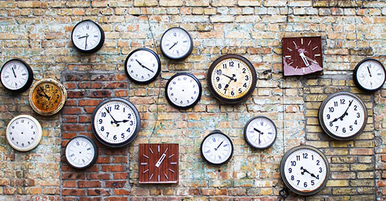 Collection of vintage clock hanging on an old brick wall