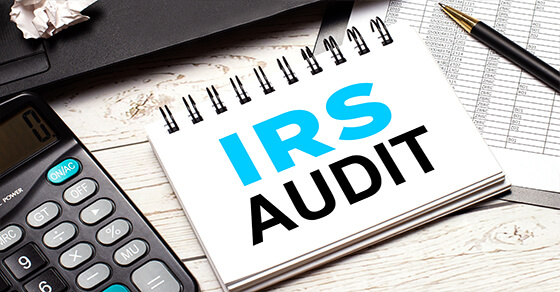 flip calendar with the words "IRS AUDIT", next to a calculator