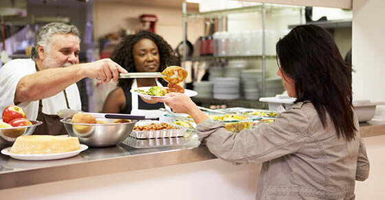 Kitchen Serving Food In Homeless Shelter