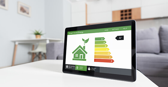ipad screen, image of a green house. A chart next to it shows green as "A" to red as "F"
