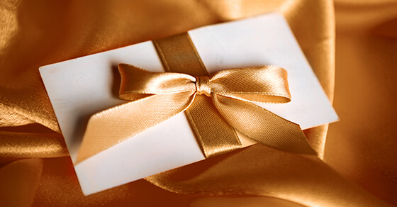 image of an envelope wrapped in a bow. 