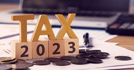 Tax wooden letter and 2023 number on wooden block.Pay tax in 2023 years. The new year 2023 tax concept.Income tax return.