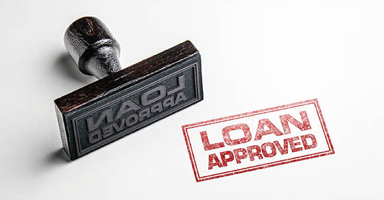 Rubber stamping that says 'Loan Approved'.