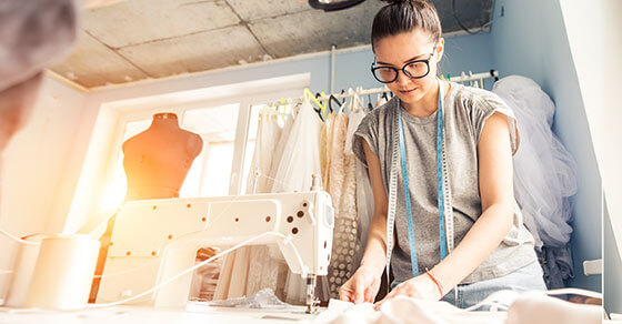 Image of a person sewing clothing using a sewing machine