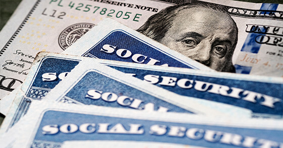 image of US money and social security checks on a table.