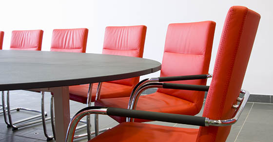 Red leather armchairs in a meeting room