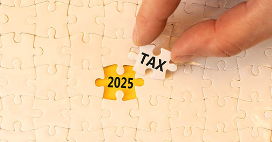 Planning 2025 tax new year symbol. Concept words 2025 Tax on beautiful white puzzle. Beautiful white puzzle background. Businessman hand. Business 2025 tax new year concept. Copy space.