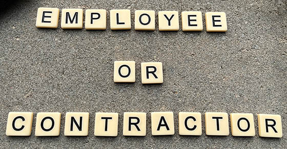 Concept image of tiles spelling employee or contractor