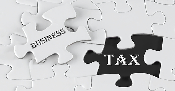 a puzzle with one of the pieces that says "business" and the gap that says "tax". 