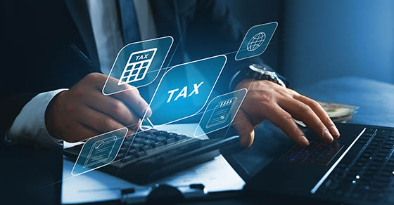 Financial research,government taxes and calculation tax return concept. Businessman using the laptop to fill in the income tax online return form for payment.