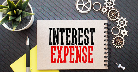 Business concept.Text Cash-out Refinance with banknote,pen and calculator on wooden table background.