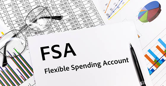 Flexible spending account FSA written on the sheet. pen, glasses, documents, graphics.