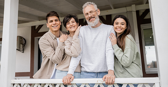 image of a family, parents and childen, smiling together.